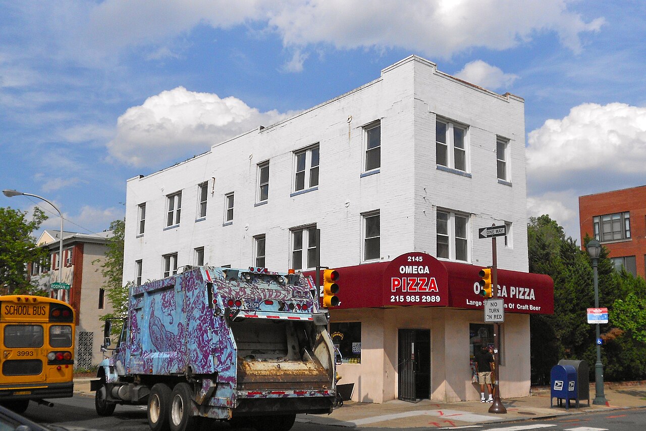 A garbage truck parked in front of the building at 2145 South Street in Philadelphia