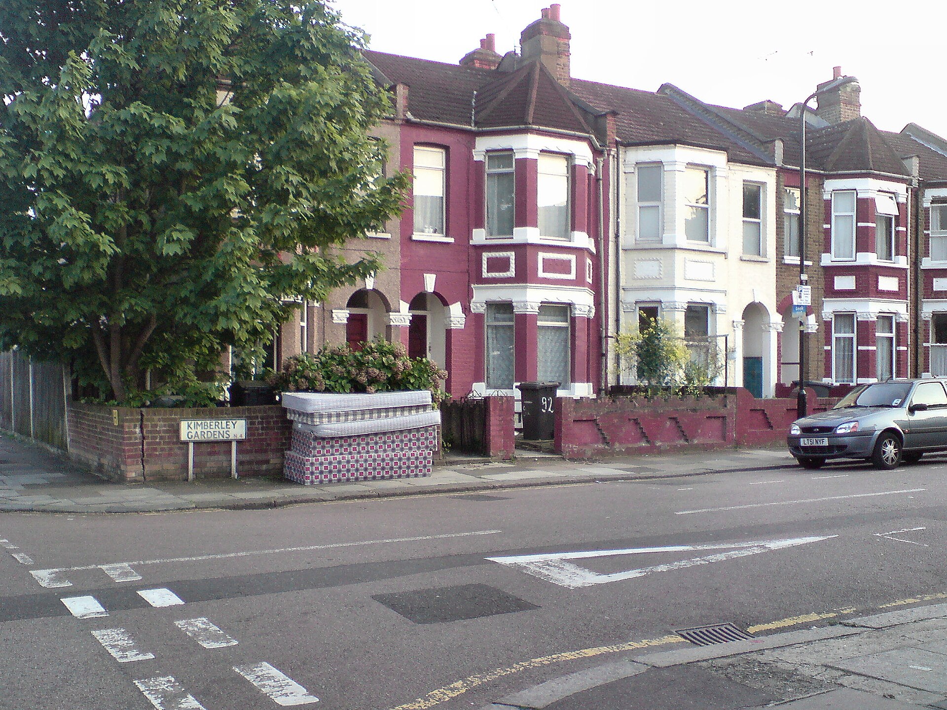 Three discarded mattresses and two bed bases left on a street in London