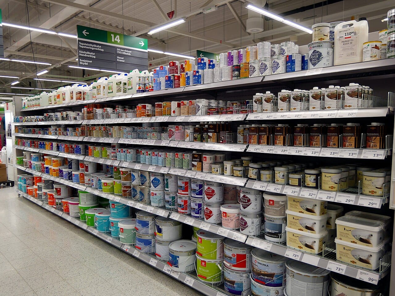 Paint cans arranged on shelves in a store