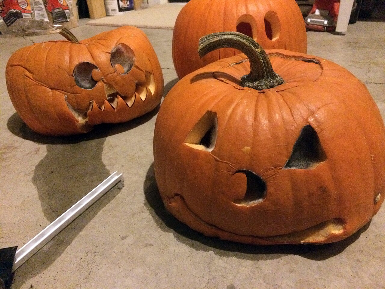 Carved jack-o'-lanterns collapsing and rotting on a doorstep after Halloween