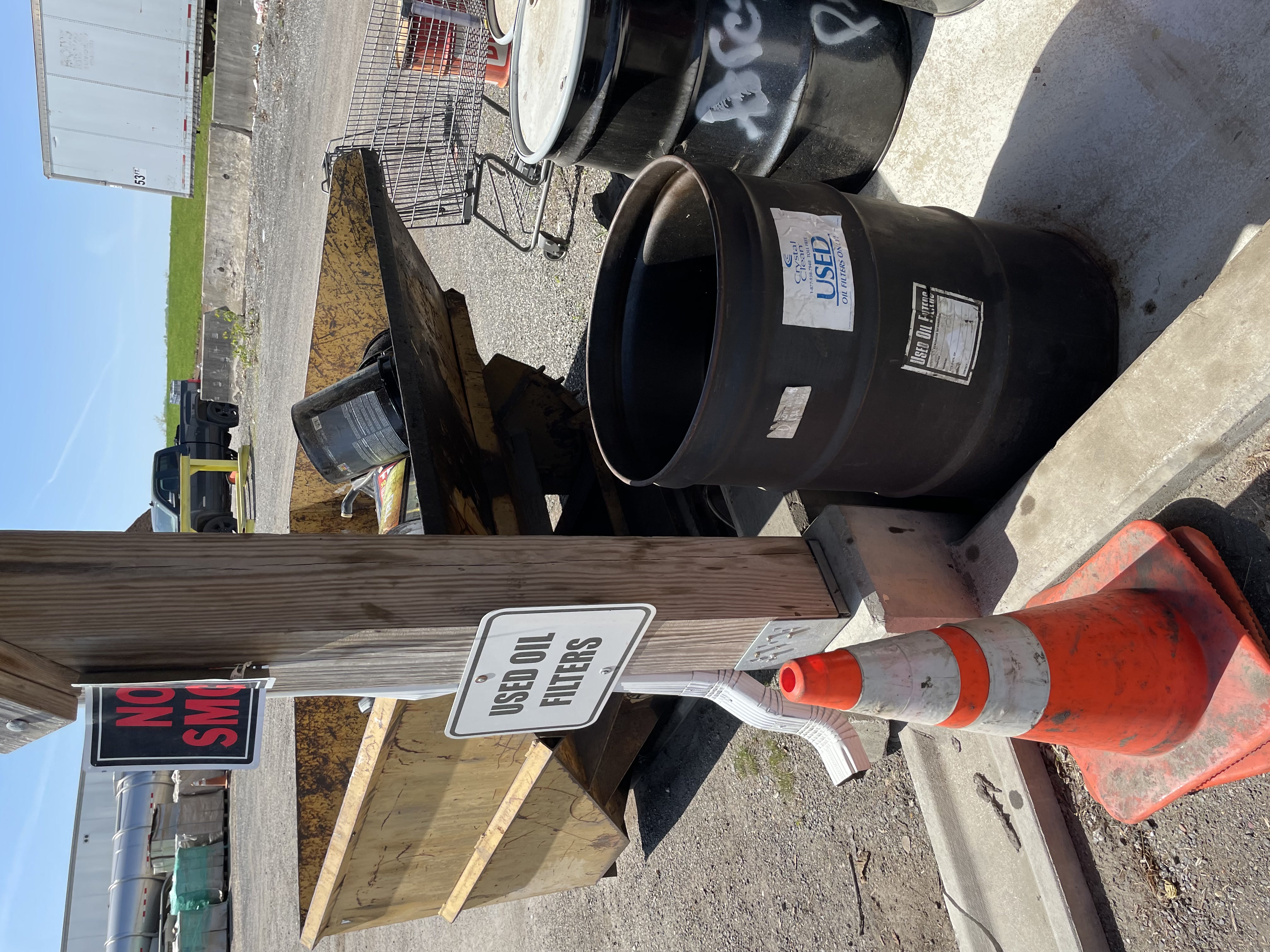 A used-oil-filter collection barrel beside a labeled sign at Baltimore County Central Acceptance Facility.